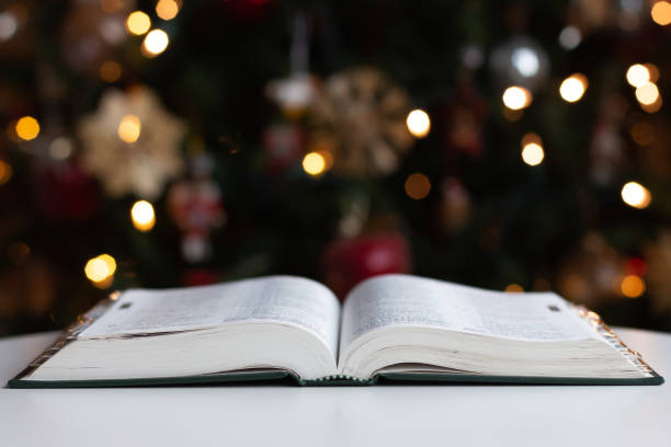 Image of bible with chritmas lights in background.